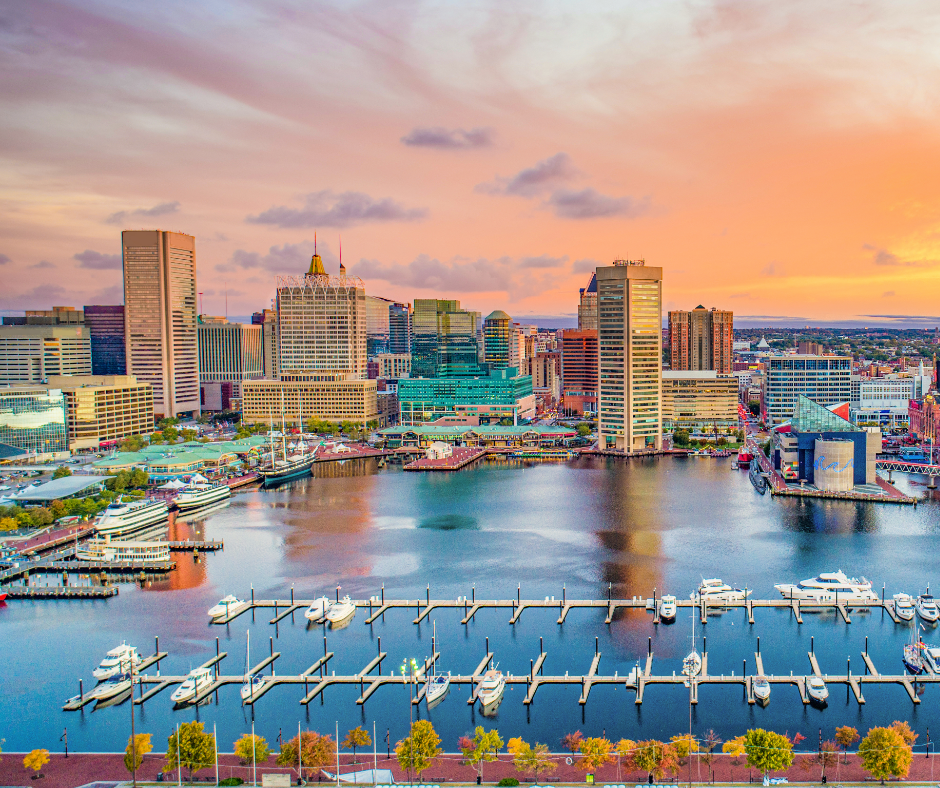 Baltimore waterfront with city skyline and sunset in background