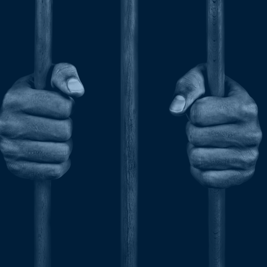 hands grasping jail bars