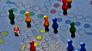 game pieces in different colors shaped like people on a surface with different colored circles