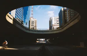 looking up through a circular underpass at the downtown area of a city